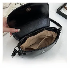 Internal view of the black saddle bag showing main compartment and inner zipper pocket