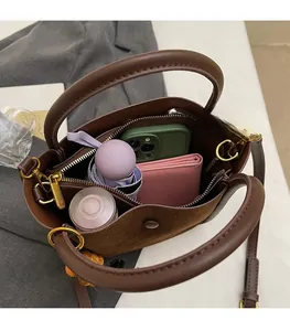 Detailed interior of a brown bucket bag showing large capacity for various daily items