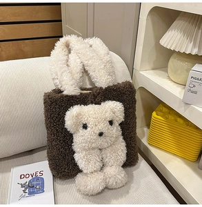Detail of plush brown shoulder bag featuring a 3D cream teddy bear and fuzzy handles