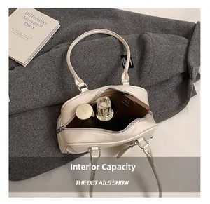 Detail view of cream soft leather tote bag interior showing capacity for daily essentials