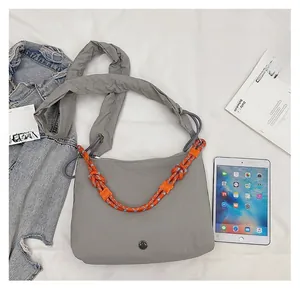Detail view of grey crossbody bag with thick woven rope and wide padded shoulder strap