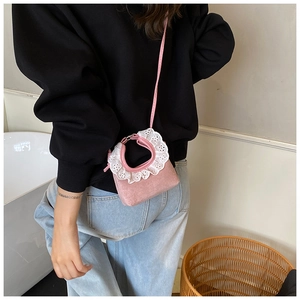 Pink mini crossbody bag featuring white lace trim and metal ring handle on model