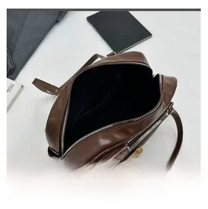 Interior layout of deep brown tote bag featuring zipper pocket and multiple compartments