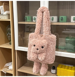 Detail of soft pink plush tote bag featuring a cute 3D cartoon bear design and furry straps
