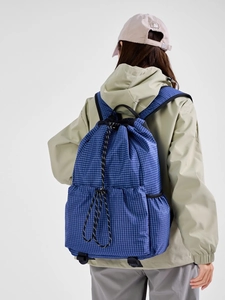 Blue grid drawstring backpack for sports and travel with a large capacity design
