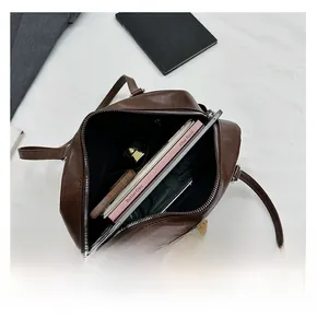 Top view of spacious brown leather tote bag interior showing capacity for tablet and notes