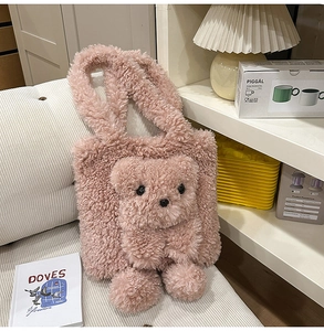 Detailed close-up of pink faux shearling tote bag with 3D teddy bear toy on sofa