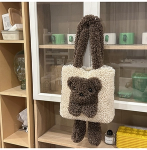 Detail of creative 3D plush bear tote bag with fluffy cream texture and brown bear face