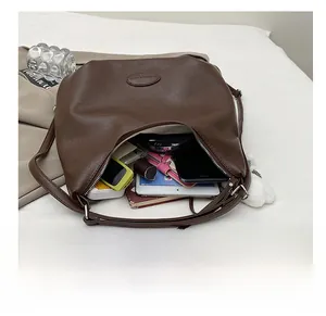 Detail showing the large interior capacity of this retro brown faux leather tote bag