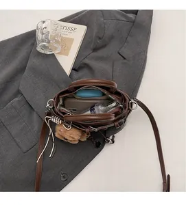 Interior view of brown leather handbag showing large capacity for phone and cosmetics