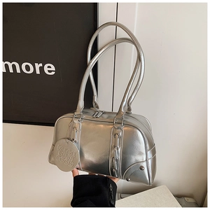 Detail of silver metallic leather Boston bag with metal chain decor and embossed pendant