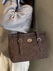 Brown large capacity leather tote bag with white stitching and adjustable strap