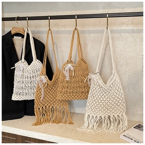 Detailed macro view of handmade crochet hollow mesh texture with elegant tassel design