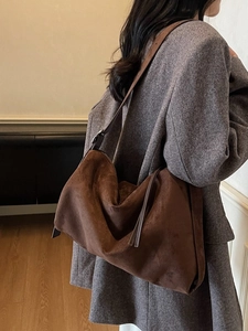 Classic dark brown suede shoulder bag with long fringes and adjustable strap for women