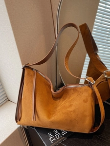 Caramel brown suede hobo bag with fringe tassel detail and slim shoulder strap