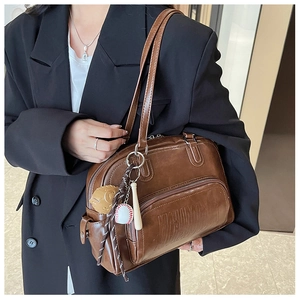 Detailed view of brown retro tote bag with YINGADU logo and baseball charms
