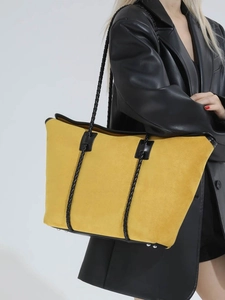 Chic yellow suede tote bag with black woven straps and metal feet for stylish daily commute