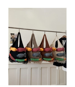 Detail view of knitted tote bags with colorful 3D fish appliques and long fringe tassels