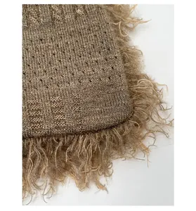 Detail of custom knitted fabric texture and durable brown fringe edge of the tote bag