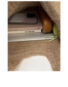 Top view of the spacious interior of a brown knitted tote bag showing daily items
