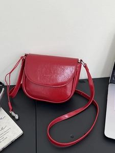 Minimalist red faux leather saddle bag with shoulder strap and silver peanut pendant