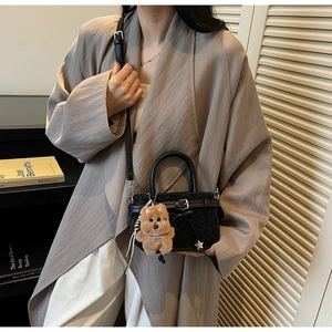 Chic black leopard pattern mini handbag with buckle detail and plush dog charm
