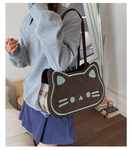 Detail of creative cat tote bag with brown suede finish and blue plaid stitching on side