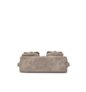 Detail showing the bottom structure and double pockets of a khaki canvas crossbody bag