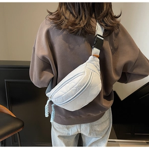 Vue arrière d'un sac de poitrine en toile matelassée bleu clair avec sangle en nylon