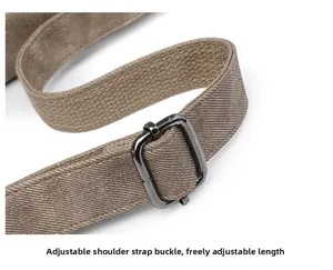 Detail of adjustable khaki shoulder strap with gunmetal buckle for versatile length control