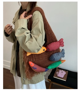 Brown knitted tote bag featuring colorful fish charms and bohemian tassel details