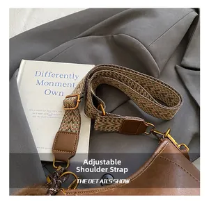 Detail of adjustable woven strap and brown leather texture on a stylish crossbody bag