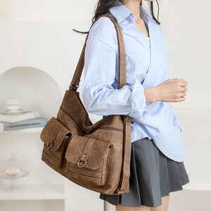 Brown vintage multi-pocket crossbody bag with matte faux leather texture and wide strap