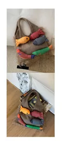 Close-up of brown knit tote bag featuring colorful handmade fish charms and fuzzy trim