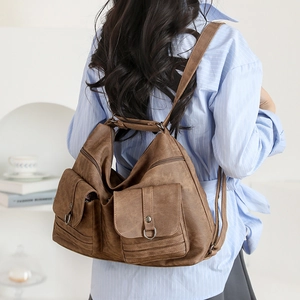 Detailed view of brown vintage textured leather backpack with dual front pockets