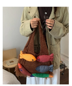 Detail of a brown knit tote bag with five colorful 3D fish charms and wave textures