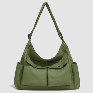 Détail du sac fourre-tout vert armée avec poches avant à rabat et tissu texturé durable