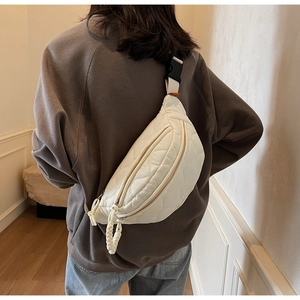 Vue détaillée du sac bandoulière matelassé blanc cassé avec sangle et boucle au dos
