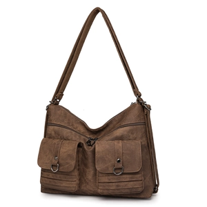 Detailed view of dark brown crossbody bag with multi-pockets and metal D-ring accents