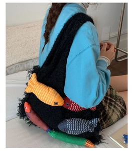 Detailed close-up of a black furry tote bag featuring colorful hanging fish charms