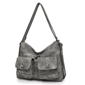 Front detail of a large dark grey vintage tote bag with two front flap pockets and buckles