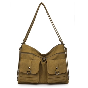 Detail view of mustard yellow canvas backpack featuring vintage dual front flap pockets