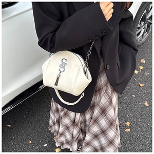 Detailansicht weiße Muscheltasche aus genarbtem Leder mit Quaste und Silberkette