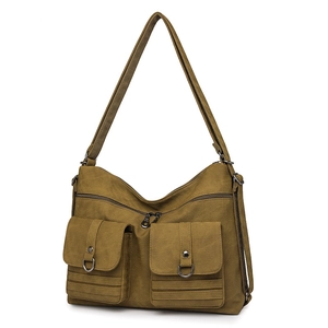 Detail view of army green canvas tote bag featuring dual cargo pockets and metal D-ring accents