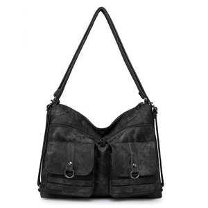 Close-up of vintage black crossbody bag showing front pockets and textured soft leather