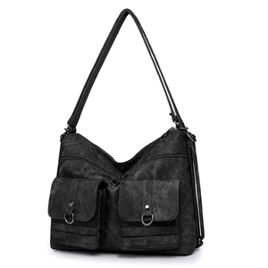 Detailed view of black vintage canvas tote bag featuring dual front pockets and metal snaps