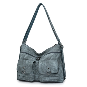 Detailed macro view of vintage washed canvas bag with adjustable strap and metal hardware