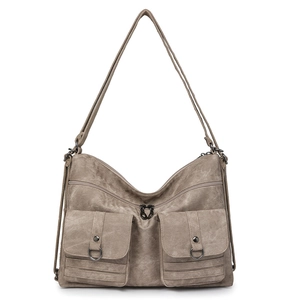 Detailed macro view of khaki retro textured shoulder bag with utility pockets and buckles