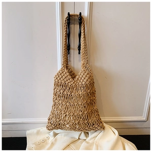 Detailed view of handmade woven mesh tote bag featuring natural texture and cotton straps