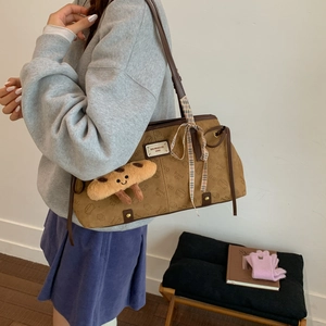 Détail du sac rétro marron avec motifs de chat, nœud en ruban et pendentif toast en peluche